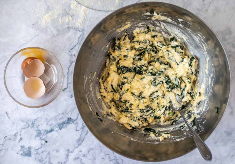 A Rudarska Greblica, a traditional Croatian recipe, consisting of a bowl with eggs and spinach in it.