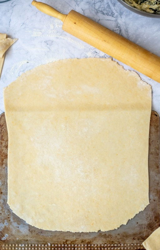 A sheet of dough and rolling pins on a counter, used in a Croatian Recipe.
