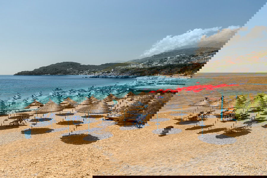 Things To Do In Himare, Albania - Sunbathers on the beach in Himare resort, Albania.
